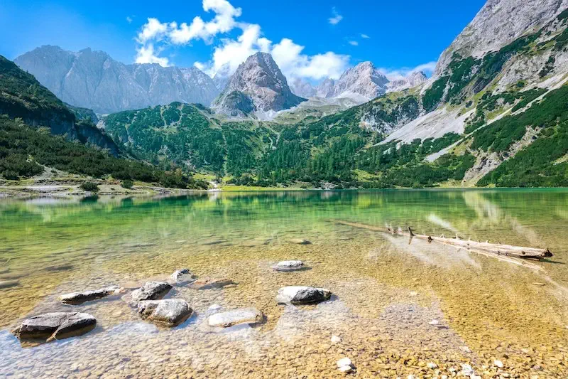 Crystal clear lake view with the Alps in the background