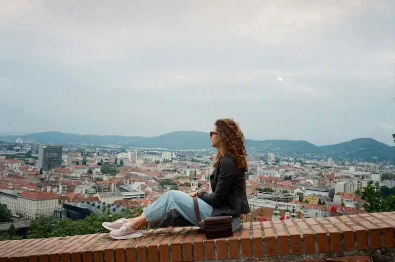 Woman sitting and overlooking an Austrian city