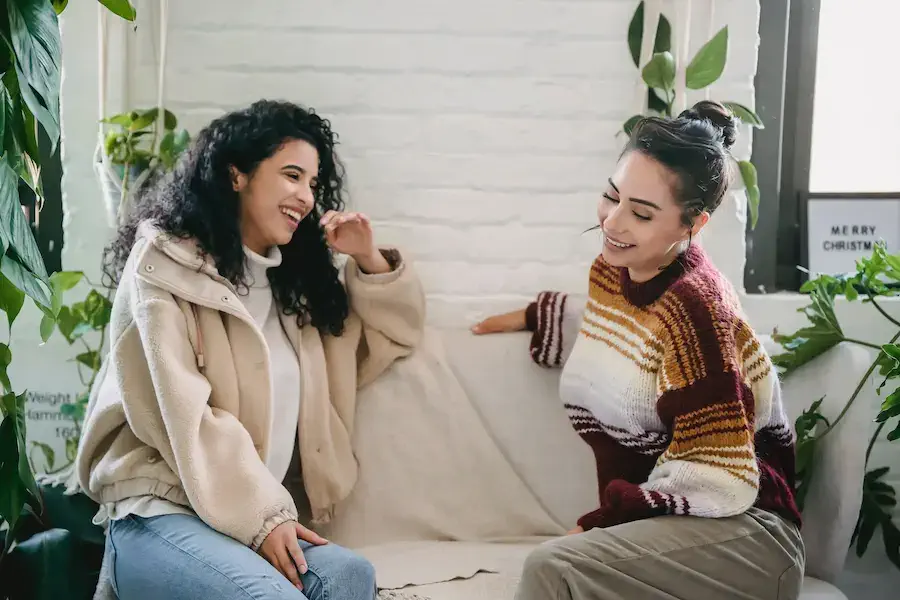 Two women chatting on a couch