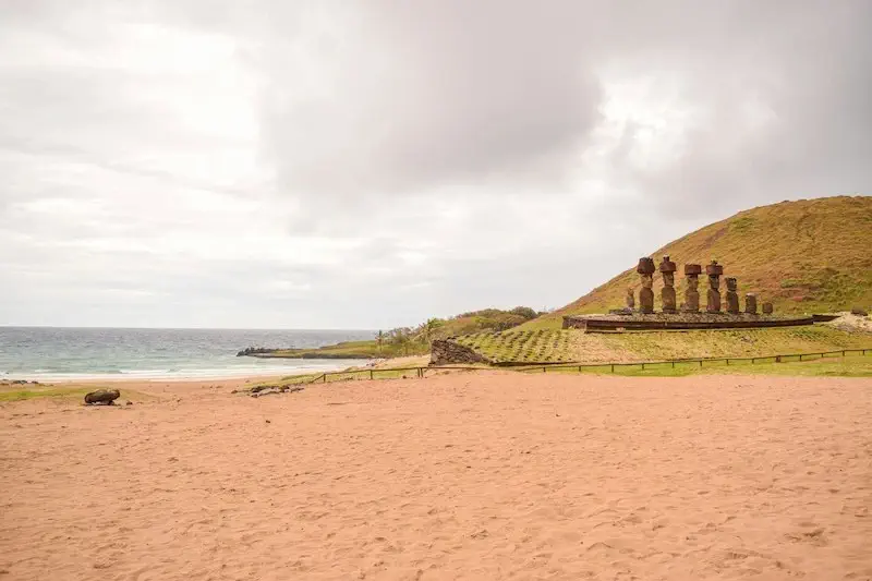 Sandy beach with Moai statues in the background