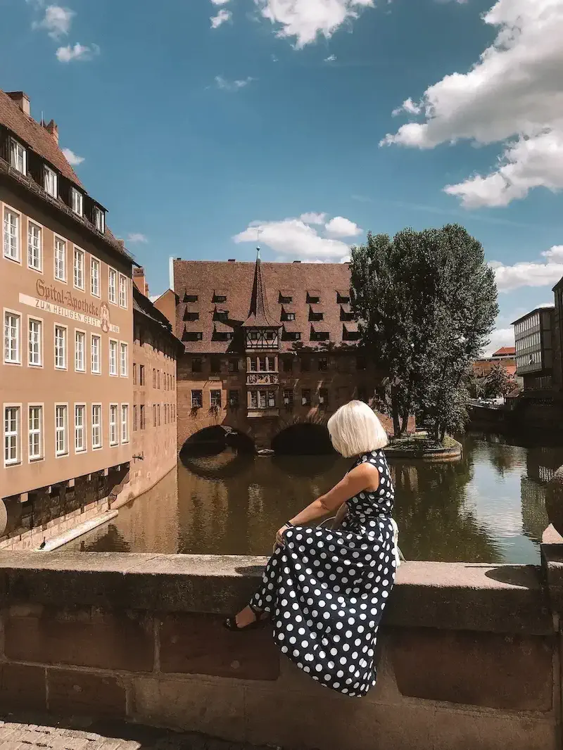 woman sitting on bridge